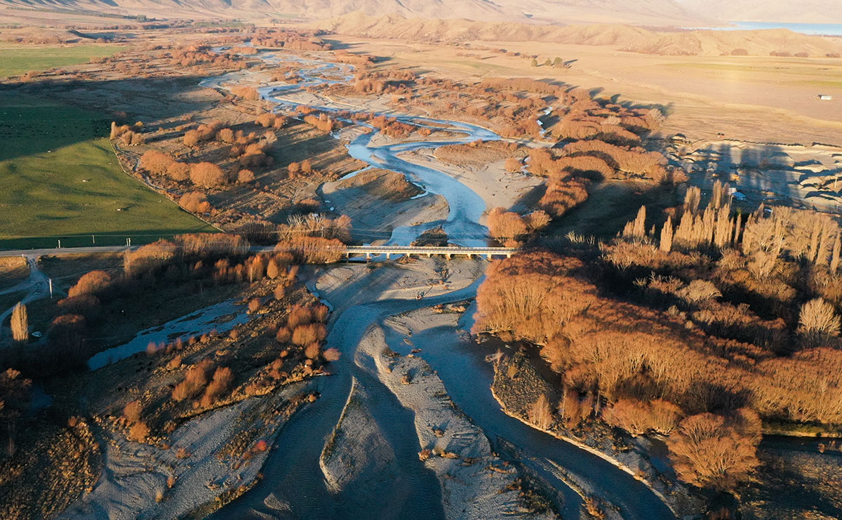 clutha river bridge powerlines fields hills 