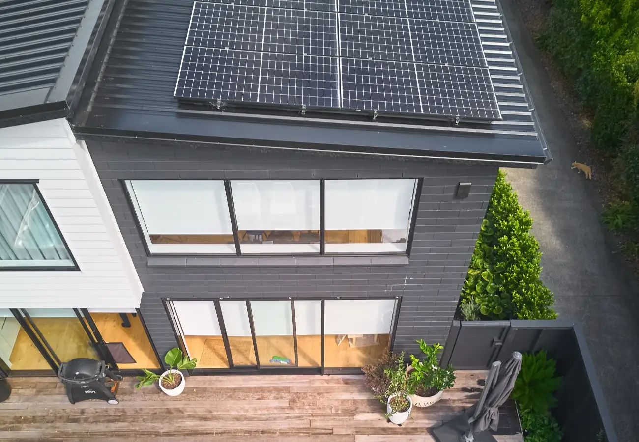 View of a modern, two-storey townhouse with solar panels.. 
