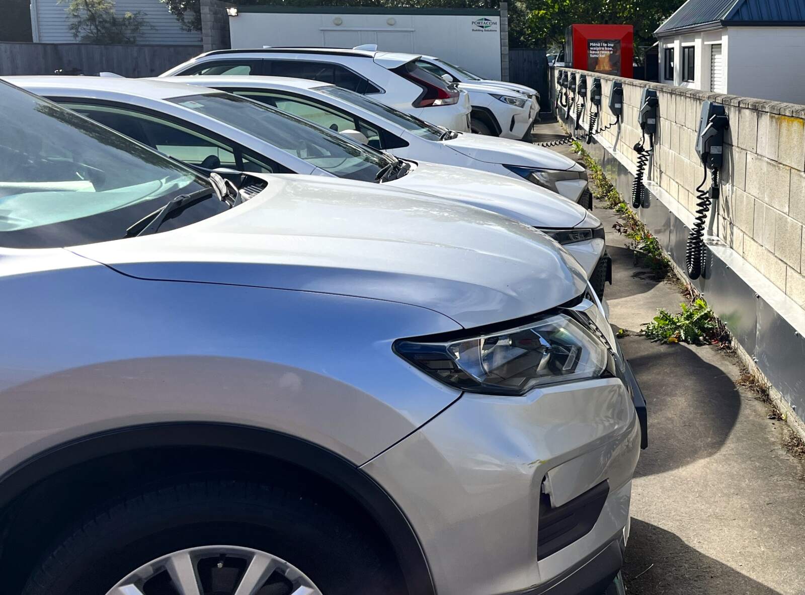 EVs being charged by smart chargers in an open parking lot..