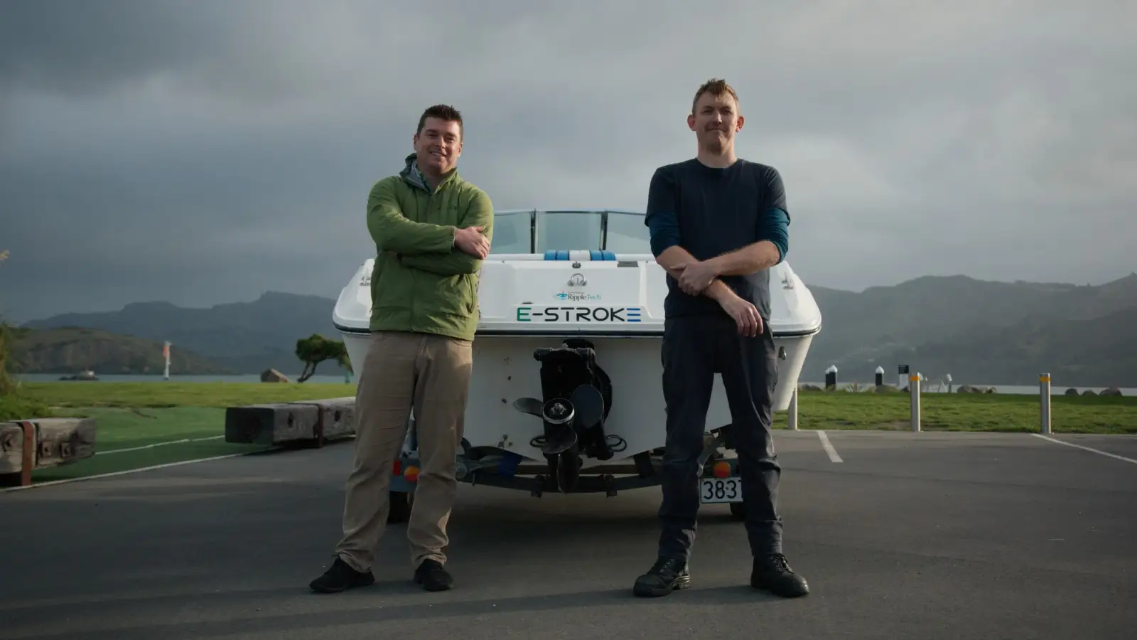 Photo of Jeff and Michael Smit standing in front of their electric boat.. 